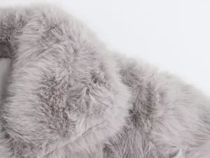Close-up detail of grey faux fur coat fabric, soft fluffy texture for winter fashion.