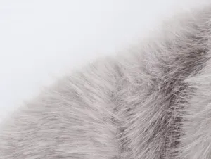 Close-up detail of grey faux fur fabric texture for women short coat winter apparel.