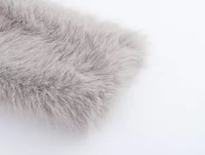 Close-up detail of soft grey faux fur fabric, showcasing plush and fluffy texture.