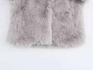 Faux fur coat detail showing soft plush texture and front hem design in elegant gray.
