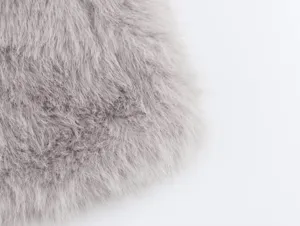 Close-up detail of grey faux fur short coat fabric, showing soft plush texture and cozy design.