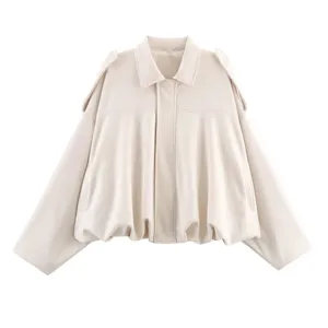 Close-up detail of the cream faux leather bomber jacket, featuring lapel collar and hem.