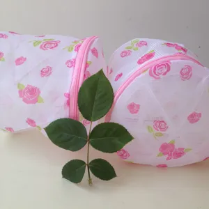 Cylindrical mesh laundry bag with pink rose print, delicate zipper for underwear washing protection.