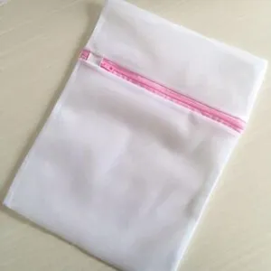 White mesh laundry bag with pink zipper for delicate clothing washing protection detailed view.