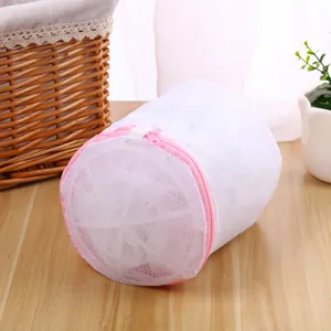 White cylindrical mesh laundry bag with pink zipper for delicate underwear and bras washing