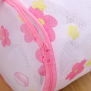 Floral mesh laundry bag with pink zipper for delicate clothes, durable washing organizer.