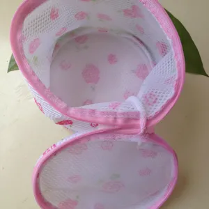 Close-up detail of pink floral laundry mesh bag for washing bras and underwear safely.