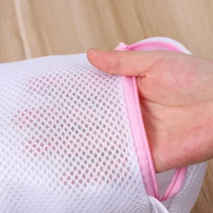 White mesh bra laundry bag detail view, breathable sandwich mesh with pink zipper closure.