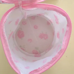 Detailed view of the pink mesh laundry bag interior, showing fine mesh and zipper structure.