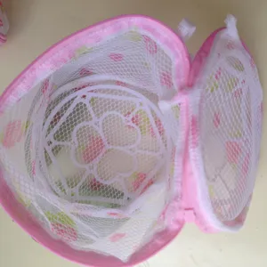 Detail view of pink mesh bra laundry bag showing inner support frame and mesh material.