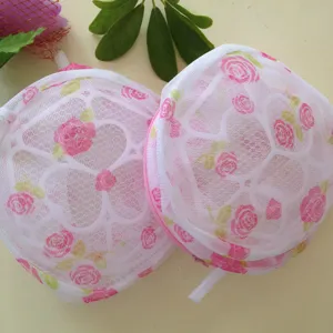 Detail view of the fine mesh bra laundry bag with pink rose floral print, zipper and hanging loop.
