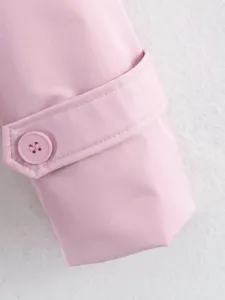 Pink trench coat sleeve detail shot, featuring stylish button and adjustable cuff strap.