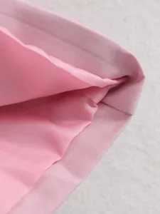 Pink trench coat fabric detail, soft inner lining and neat stitching closeup view.