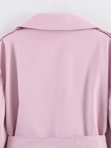 Pink trench coat back detail, lapel collar and belt closeup view showcasing the garment texture.