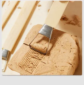 Close-up of texture rolling tool on clay block, ideal for pottery shaping and detail sculpting.