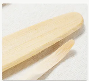 Detailed close-up shot of bamboo pottery clay sculpting tools, smooth wooden scraper carver.