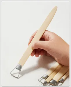 Detailed close-up of wooden clay sculpture tool with metal loop wire for pottery.