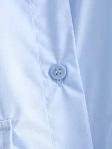 Light blue women button up shirt detail close-up showing fabric texture and neat stitching.