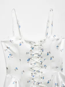 White satin camisole top featuring blue floral print, lace-up corset design and slim straps.