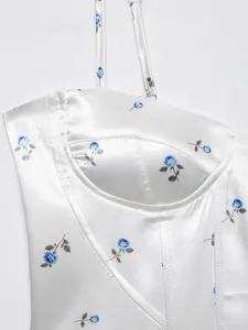Detailed view of the white satin camisole featuring a charming blue floral print and bustier.