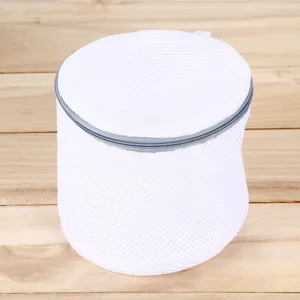 Cylindrical mesh laundry bag with durable zipper, ideal for washing delicates and bras.