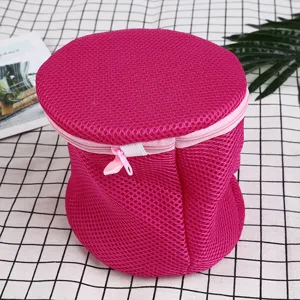 Pink cylindrical mesh laundry bag for washing bras and underwear safely in the machine.