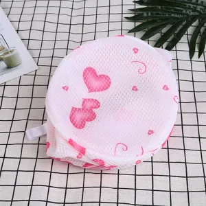 Round mesh laundry bag with pink heart pattern, durable zipper bra wash bag for delicate clothes.