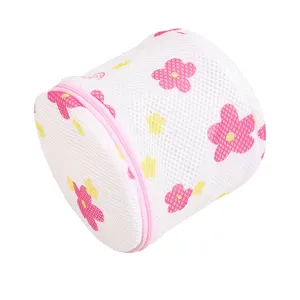 Cylindrical fine mesh laundry bag with pink floral print and zipper for delicate clothes.