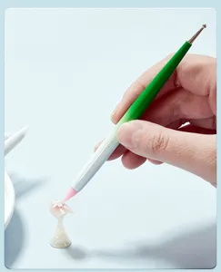 Dual ended silicone nail art pen detail showing flexible shaping tip and metal dotting ball.