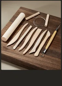Pottery clay tool set details with wooden shaping knives, rolling pin and wire for DIY craft.