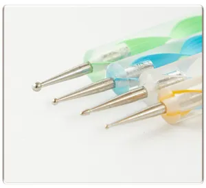 Detailed close-up of dual-ended nail art dotting pens with colorful acrylic handles and metal tips.