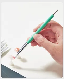 Dual-ended silicone nail art brush and dotting pen for sculpting, carving, and DIY manicures.