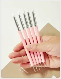 Detail view of double-ended silicone nail art brushes and dotting tools for DIY crafts.