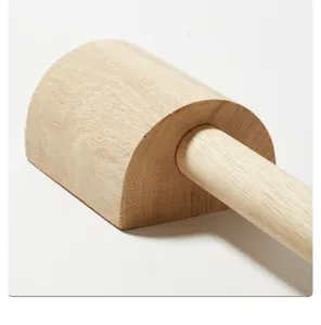 Handmade wooden pottery clay paddle tool detail shot, natural wood texture for sculpting craft.