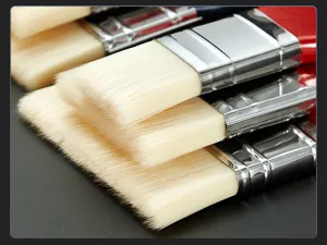 Flat paint brush detail showing soft nylon bristles and metal ferrule for art and wall painting.