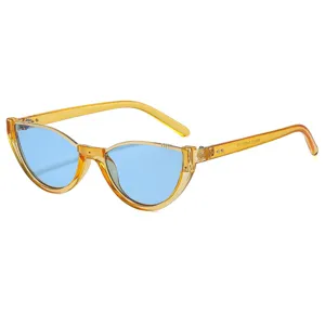Modische Katzenauge Sonnenbrille für Damen mit transparentem gelbem Halbgestell und blauen Gläsern.
