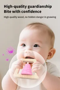 Wooden baby teether and rattle detail shot showing safe teething material for infant soothing.