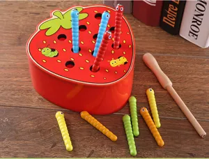 Detailed view of wooden Montessori strawberry worm catching game toy with magnetic caterpillars.