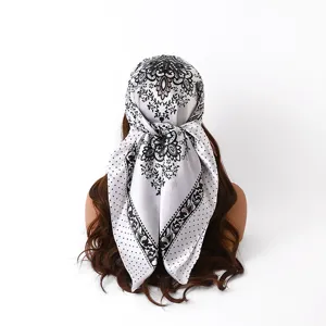 Satin silk square scarf featuring elegant floral print and classic polka dot details for hair styling.