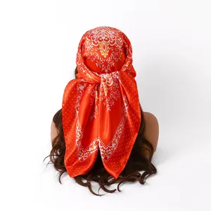 Red satin square silk scarf detail, floral paisley head wrap display from back view.