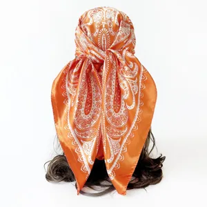 Orange and white paisley satin silk square scarf detail view, elegant headscarf and shawl.