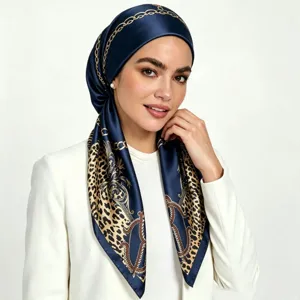 Detailed view of women's satin silk hijab with chic leopard and chain print design.