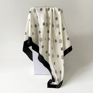 Detailed view of the elegant satin square scarf with chic camellia floral print.