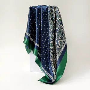 Chic paisley print silk scarf detail, elegant blue and green square headwrap for women.