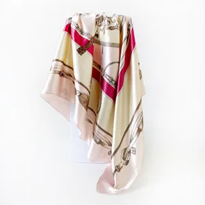 Detailed shot of luxury satin silk scarf featuring classic chain and strap print, elegant drape.