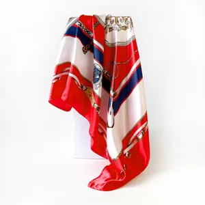 Detail view of the elegant satin silk scarf featuring classic chain and scepter print.