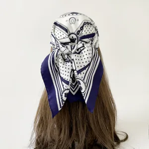 Detailed close-up view of a retro equestrian patterned head scarf tied on mannequin head.