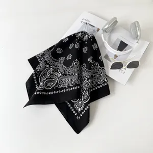 Detailed view of black white paisley bandana scarf, elegant print detail and soft texture.