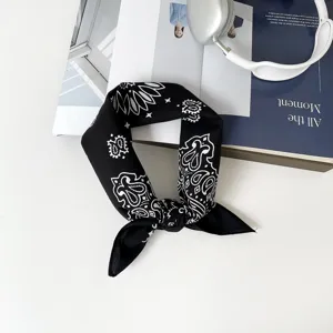 Close-up detail of black and white paisley bandana scarf, elegant fashion accessory design.