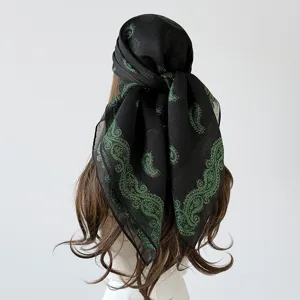 Detail view of black and green glitter paisley square scarf, elegant retro headscarf design.